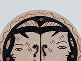 a picture of a decorative plate with a woman ' s face on it