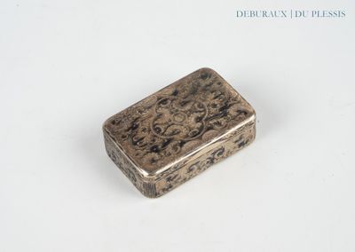 a silver box with a design on it on a white surface