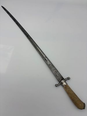 an old knife with a wooden handle on a white surface