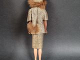doll dressed in a gold dress and fur stoler