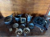 a lot of antique items on a wooden table