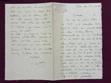 an old handwritten letter is open on a piece of paper