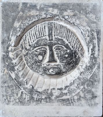 an image of a stone plaque with a face on it