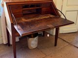 a wooden desk with a wooden top and a white curtain