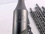 a close up of a bottle of wine next to a bunch of drill bits