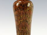 a vase that is sitting on a stand on a white surface
