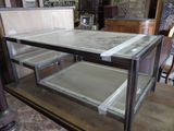 a glass display case with a marble top on a wooden table