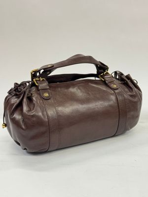 a brown leather handbag on a white background