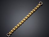 a gold chain bracelet with a clasp on a black background