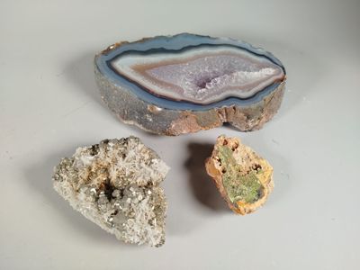 three different types of rocks on a white surface