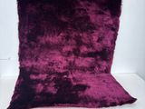 a close up of a purple rug sitting on top of a white table