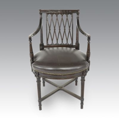 an antique chair with leather upholstered seat and wooden frame