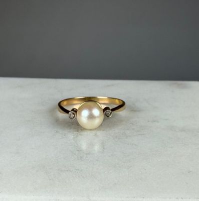 Bague en or jaune et or gris 750/1000 (18K) ornée d'une perl…