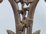 a close up of a metal object with flowers on it