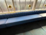 a blue couch in front of a window in a room