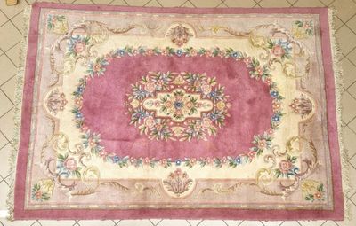 rug on the floor is pink and white with a floral design