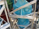 a large blue vase sitting on top of a wooden stand