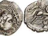 a silver coin with an image of a man riding a horse