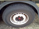 a close up view of a flat tire on a truck