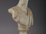 a white marble bust of a woman on a wooden base