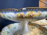a white bowl with yellow flowers on it sitting on a plate