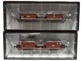 two train cars in a clear box on a white background