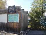 a small wooden building with a sign on it