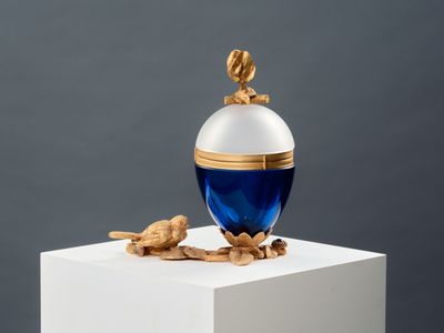 an image of a blue and white perfume bottle sitting on top of a white pedestal