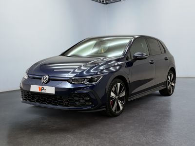 a blue volkswagen golf gtr parked in a showroom