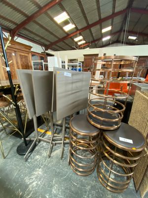 many chairs and stools in a room with a ceiling