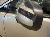 a close up of a car ' s side mirror with a sticker on it