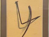 framed picture of a drawing of a letter v on a piece of wood