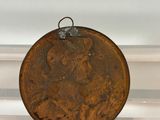 an old coin sitting on a shelf in a room