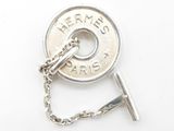 a silver button with a chain attached to it