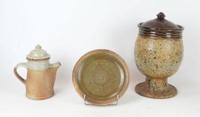 three different types of pottery sitting on a white surface