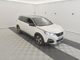 the white car is parked in the garage on the checkered floor