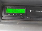 a digital clock on the dashboard of a car