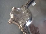 a silver plate with a mirror on it on a table