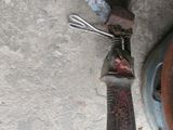 a knife that is laying on the ground next to a pot