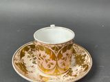 a close up of a cup and saucer on a table
