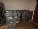 many metal bins in a room with a red door
