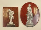 two plaques on the wall of a room with a statue on it