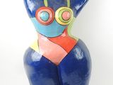 statue of a woman in a bikini with goggles on her head