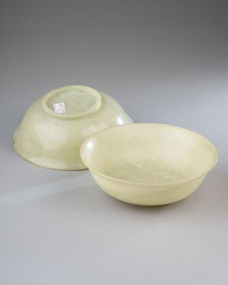 two bowls and a bowl sitting on a table with a tag on it