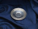 a silver plate sitting on top of a blue cloth