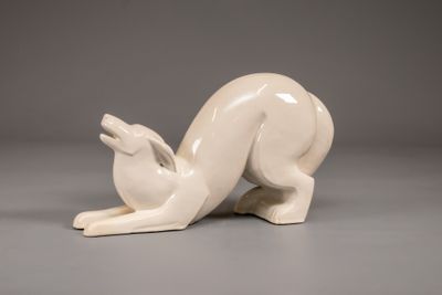 a white sculpture of a rabbit on a gray surface