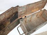 two old metal boxes sitting on a white surface
