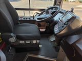 a view of the driver ' s seat of a bus from the driver ' s seat