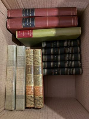 many books in a box that are stacked together