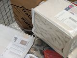 a pile of boxes sitting on the floor next to a pile of papers